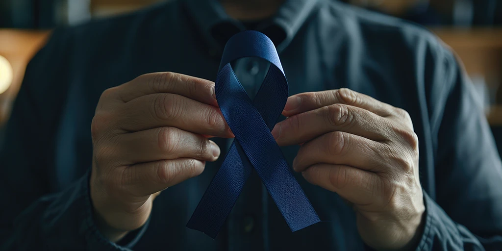 A person holding a blue ribbon